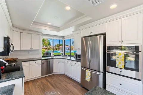 a kitchen with stainless steel appliances a refrigerator sink and cabinets