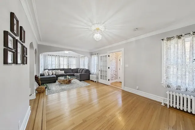 a view of a livingroom with furniture hardwood floor and a window