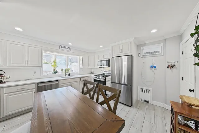 a kitchen with stainless steel appliances granite countertop a refrigerator and a stove top oven