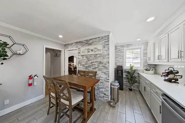 a kitchen that has a table and chairs in it
