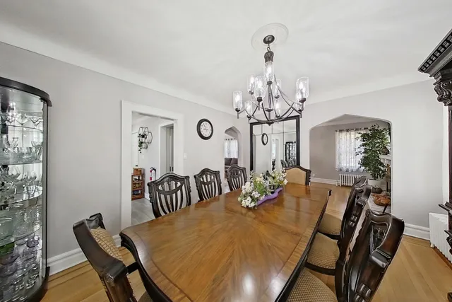 a view of a dining room with furniture and chandelier
