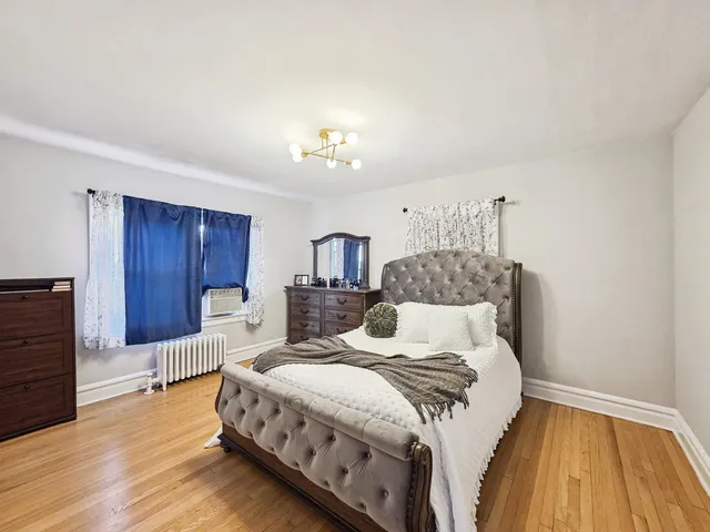 a bedroom with a bed and a dresser