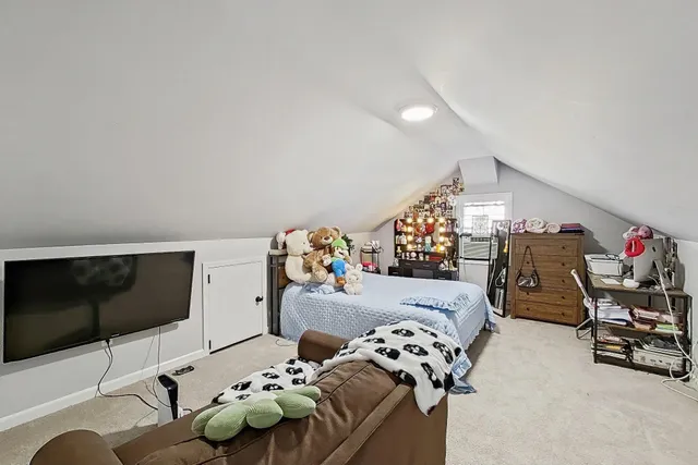 a bedroom with furniture and a flat screen tv