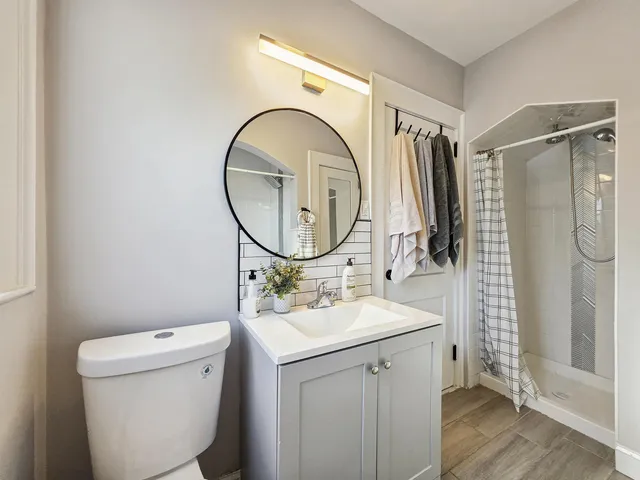 a bathroom with a sink toilet and shower