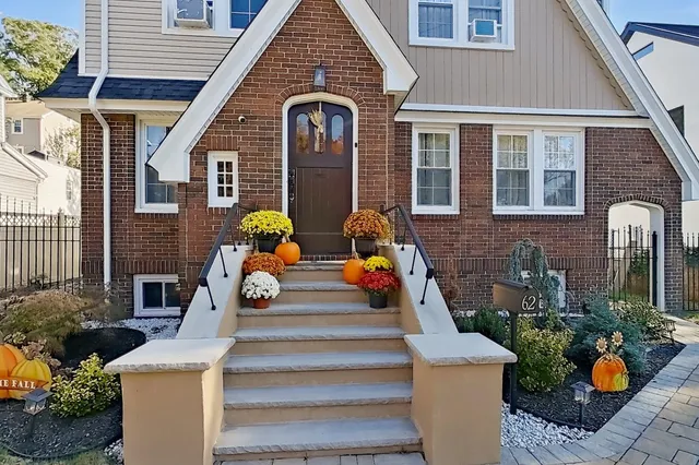 a front view of a house with outdoor seating and stairs
