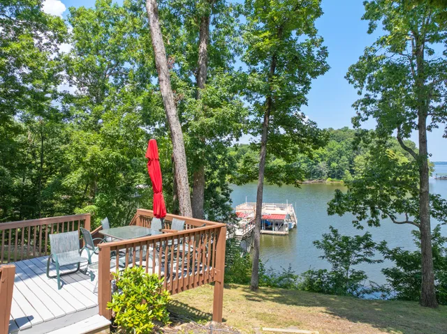 a backyard of a house with lots of green space and lake view