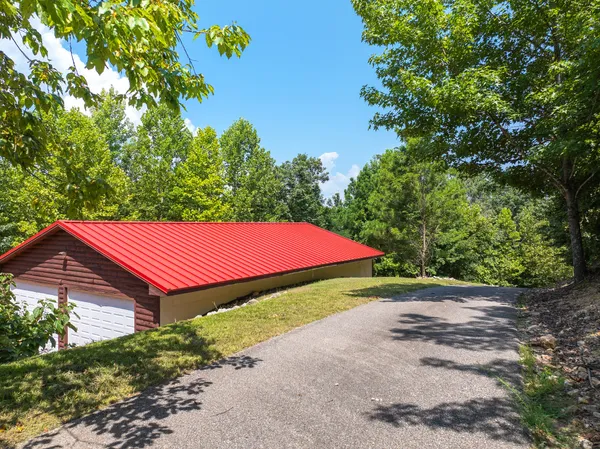 a living room with furniture a fireplace and a large window