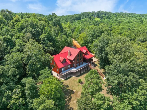 a backyard of a house with swimming pool and outdoor seating