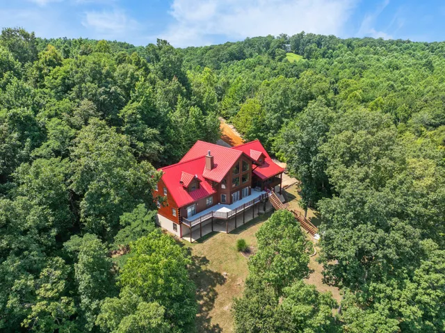 a backyard of a house with swimming pool and outdoor seating