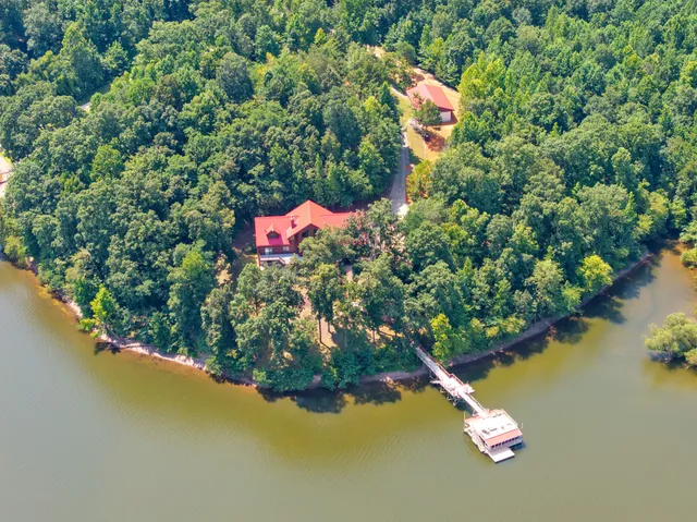 a balcony with wooden floor and yard in the back