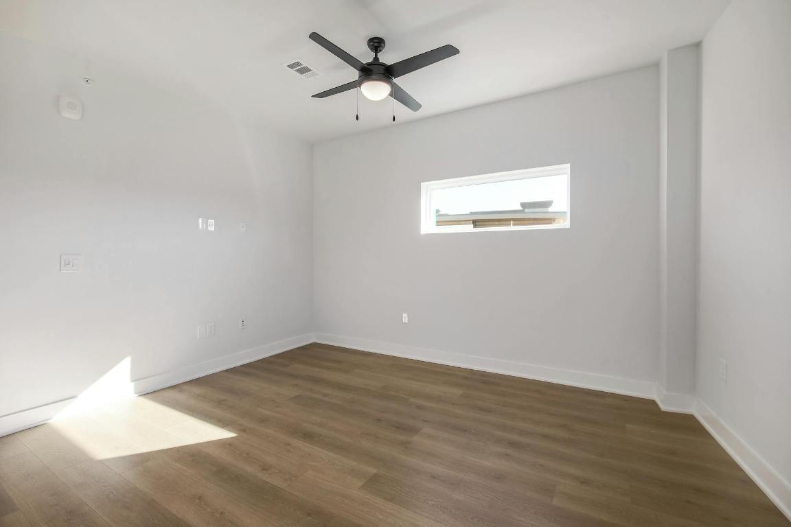 2500 Longview Street, Unit 501 Austin, TX 78705 - Photo 10 of 23 an empty room with wooden floor and a ceiling fan