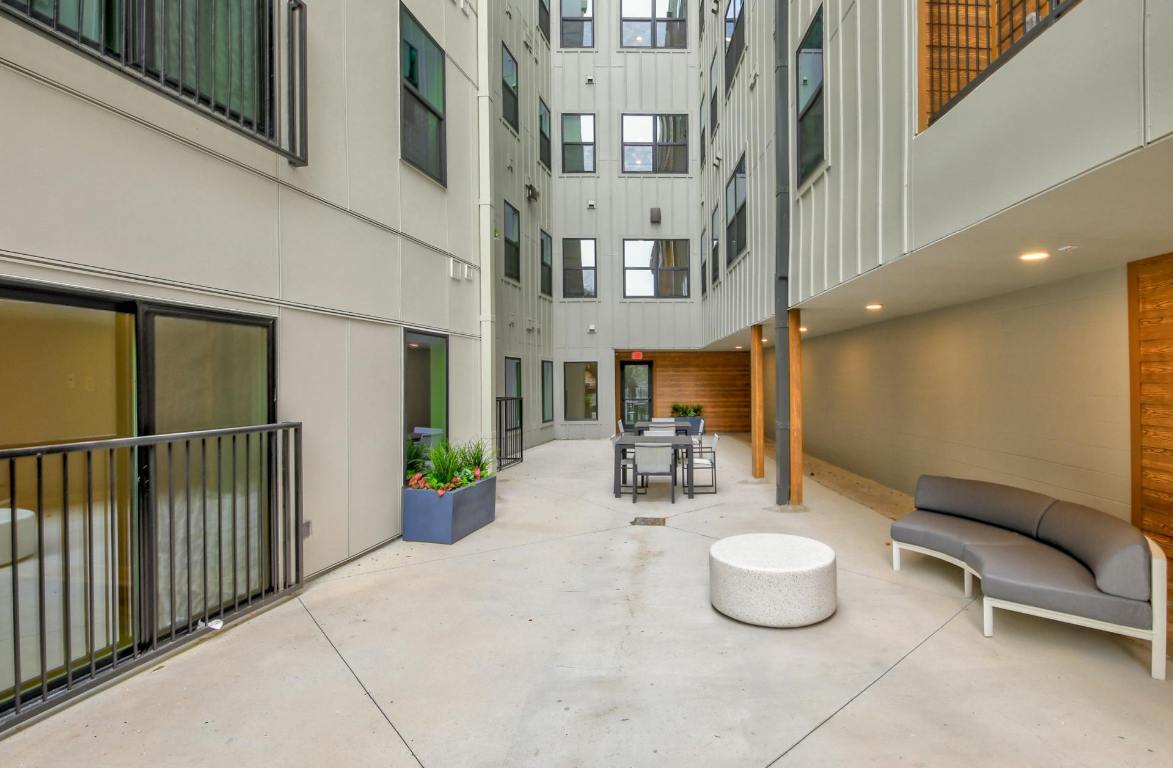 2500 Longview Street, Unit 501 Austin, TX 78705 - Photo 21 of 23 a view of a patio with dining table and chairs