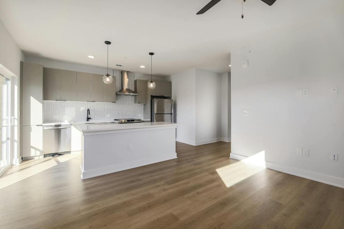 2500 Longview Street, Unit 501 Austin, TX 78705 - Photo 22 of 23 a large kitchen with hardwood floor and a sink