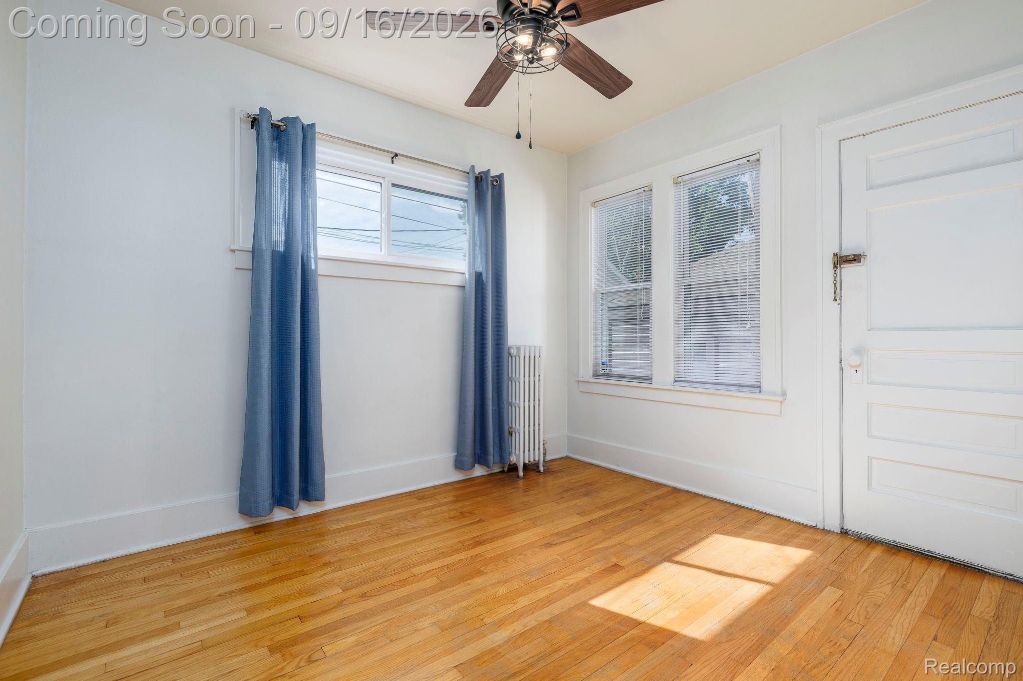 999 Nottingham Road Grosse Pointe, MI 48230 - Photo 21 of 30 Hardwood flooring throughout, ceiling fan with integrated lighting, multiple windows, and a panel-style interior door