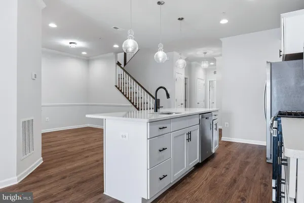 a kitchen with white cabinets stainless steel appliances and sink