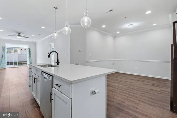 a view of kitchen with wooden floor and electronic appliances