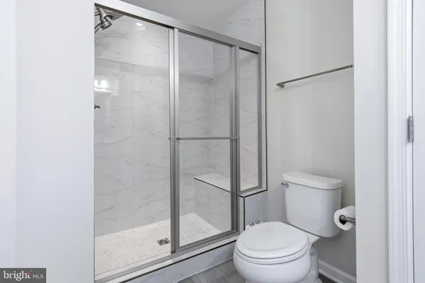 a bathroom with a glass shower door