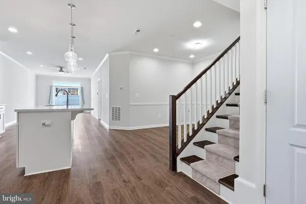 a kitchen with stainless steel appliances a refrigerator sink and cabinets