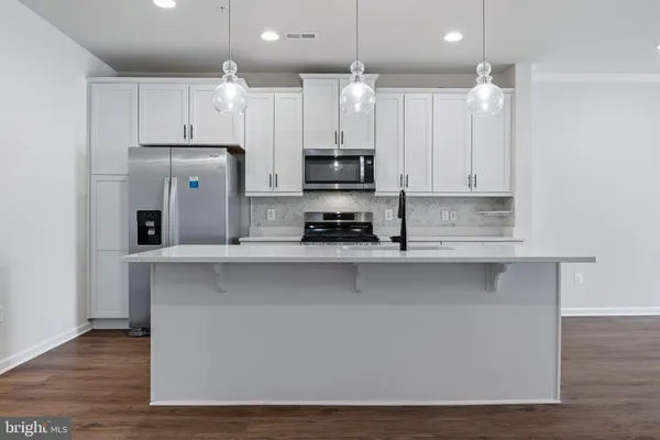 a kitchen with sink cabinets and wooden floor