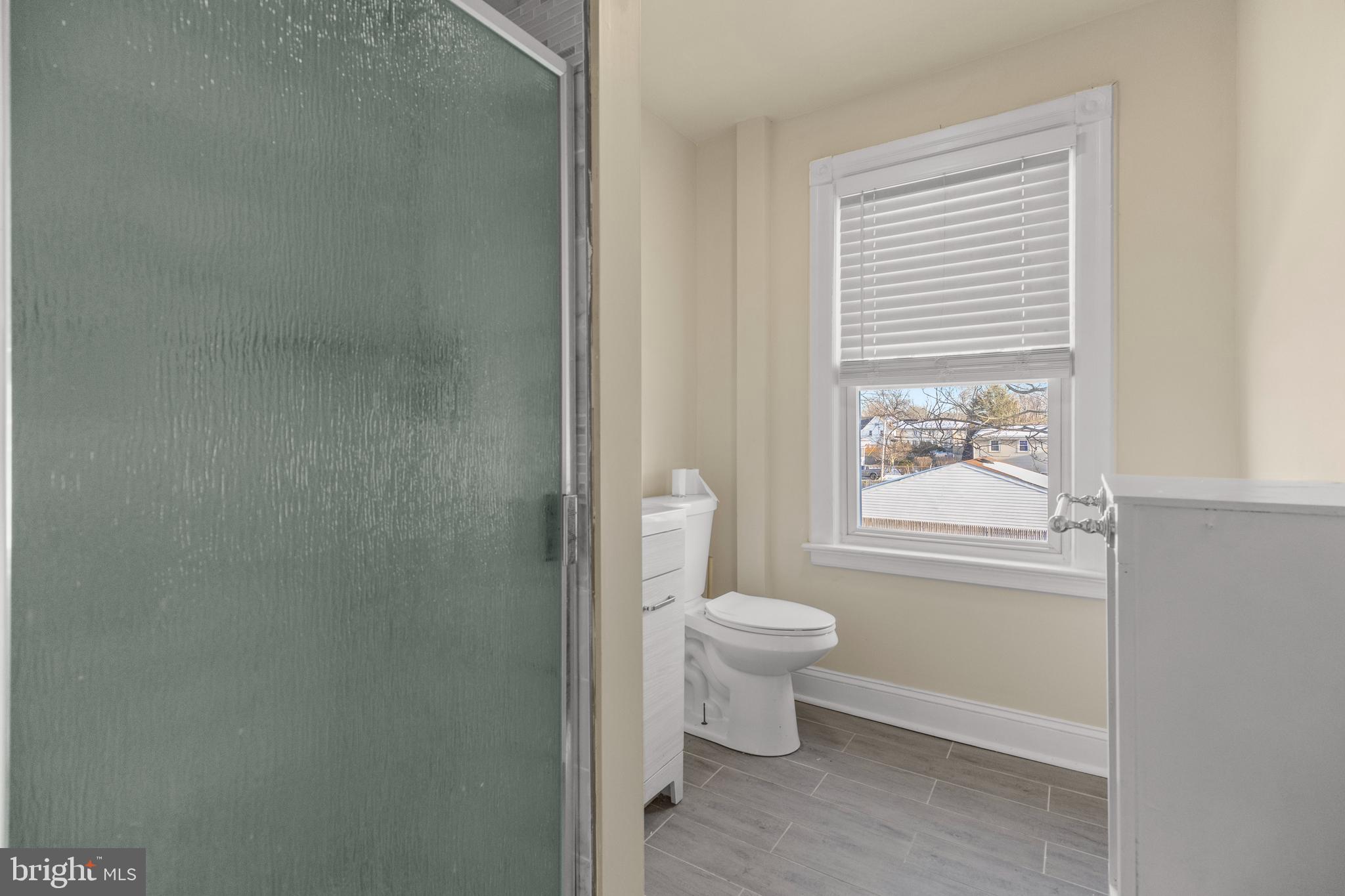 116 Chestnut Street, Unit 2 Audubon, NJ 08106 - Photo 2 of 12 a bathroom with a toilet a sink and a window