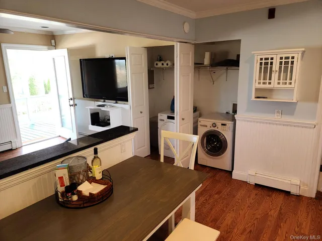 a kitchen with a stove a microwave and a wooden floor