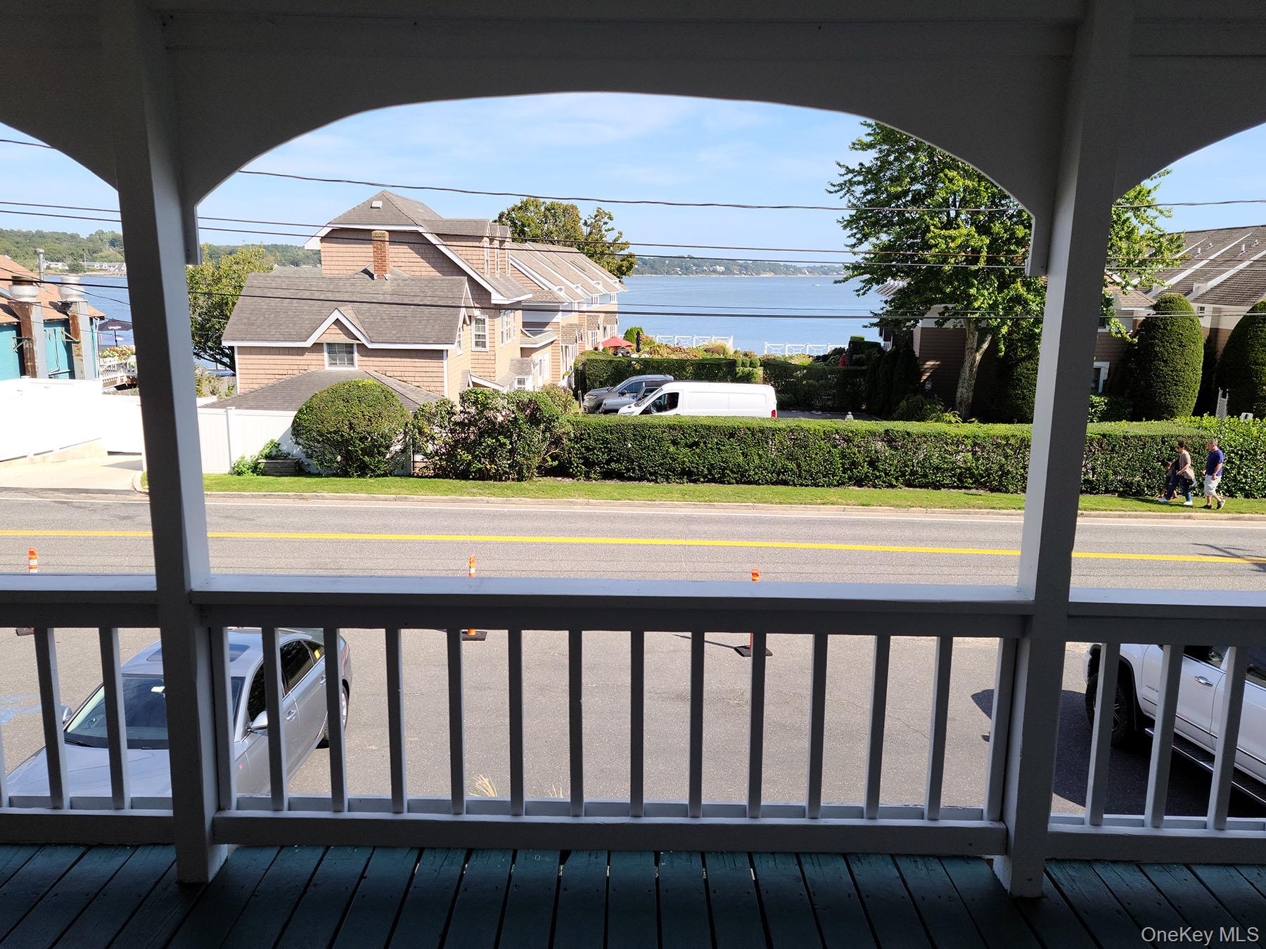 62 Canoe Place Road, Unit 627 Hampton Bays, NY 11946 - Photo 14 of 27 a view of a couple of cars parked on the street