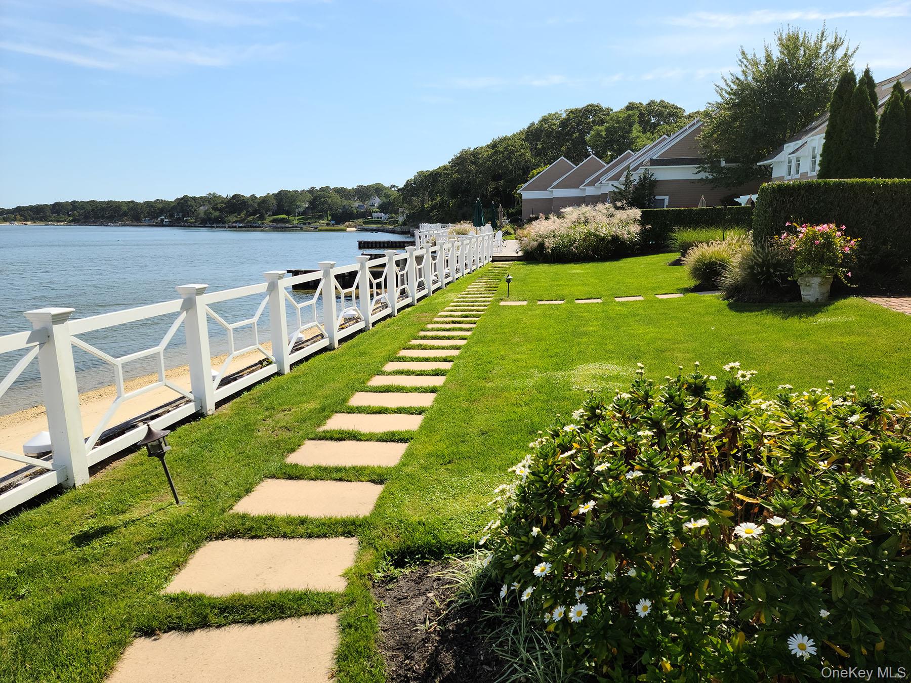 62 Canoe Place Road, Unit 627 Hampton Bays, NY 11946 - Photo 21 of 27 a view of a lake with a garden
