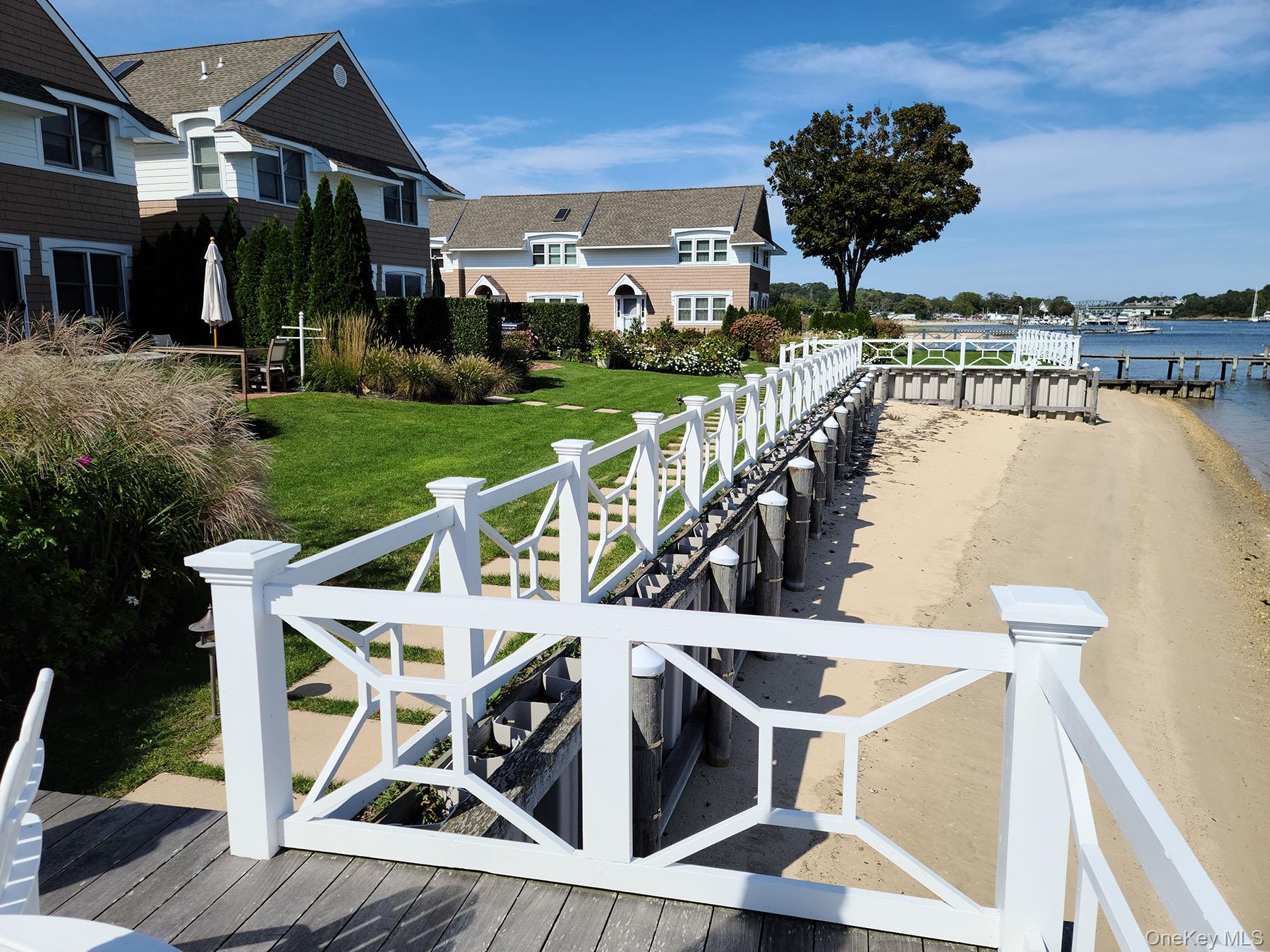 62 Canoe Place Road, Unit 627 Hampton Bays, NY 11946 - Photo 23 of 27 a view of a chairs and table on the terrace