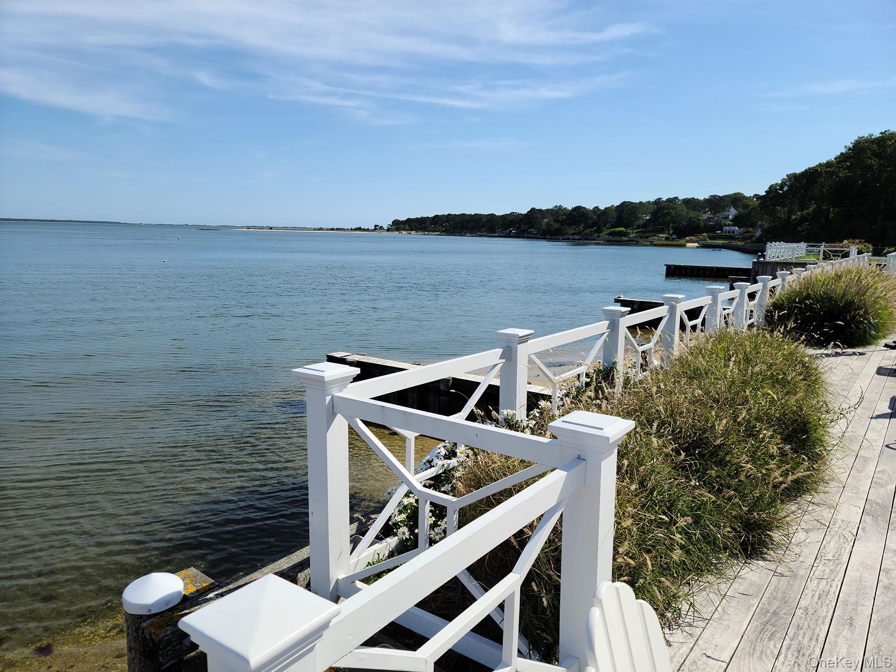 62 Canoe Place Road, Unit 627 Hampton Bays, NY 11946 - Photo 24 of 27 a view of a terrace with seating area and barbeque oven