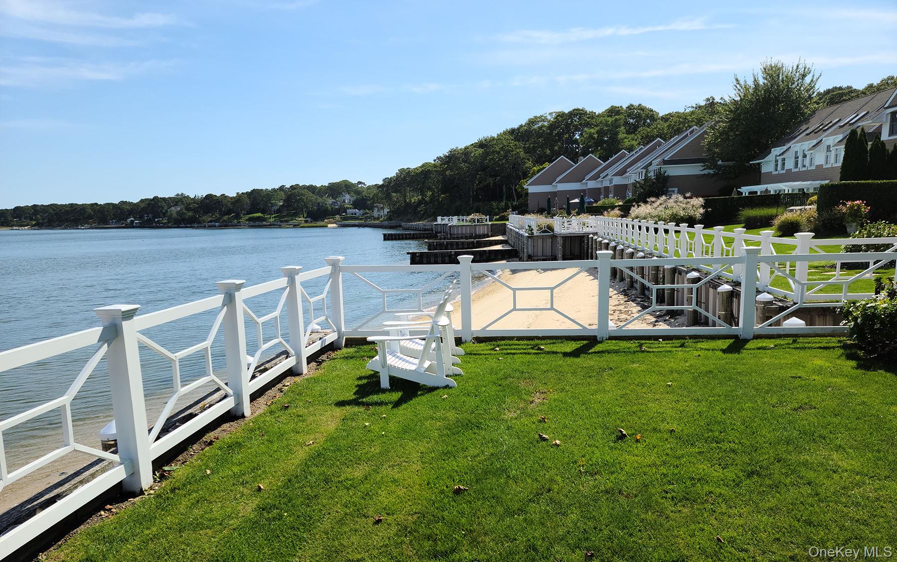 62 Canoe Place Road, Unit 627 Hampton Bays, NY 11946 - Photo 25 of 27 a view of a house with a yard and sitting area
