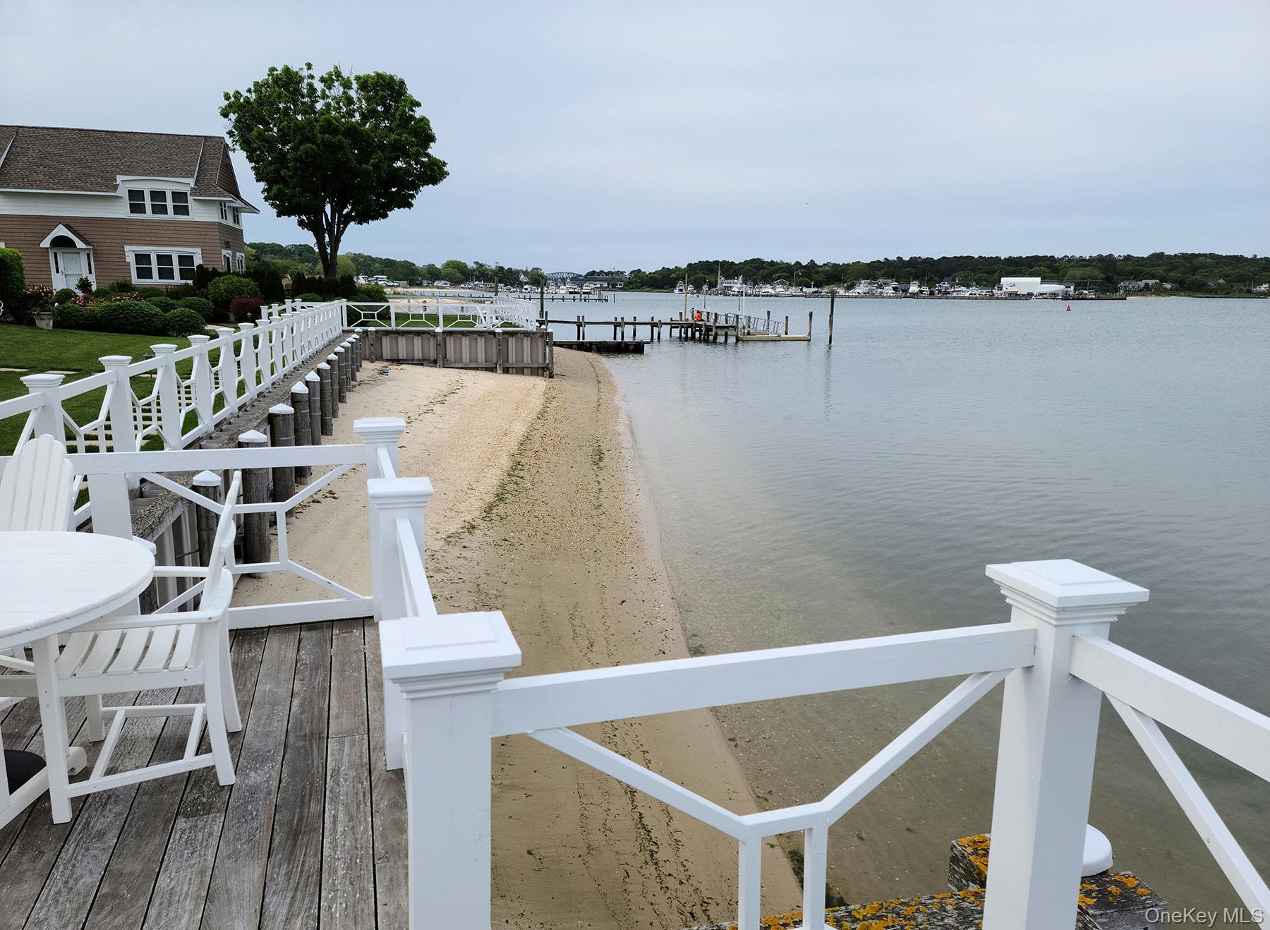 62 Canoe Place Road, Unit 627 Hampton Bays, NY 11946 - Photo 4 of 27 a terrace of a house with outdoor seating