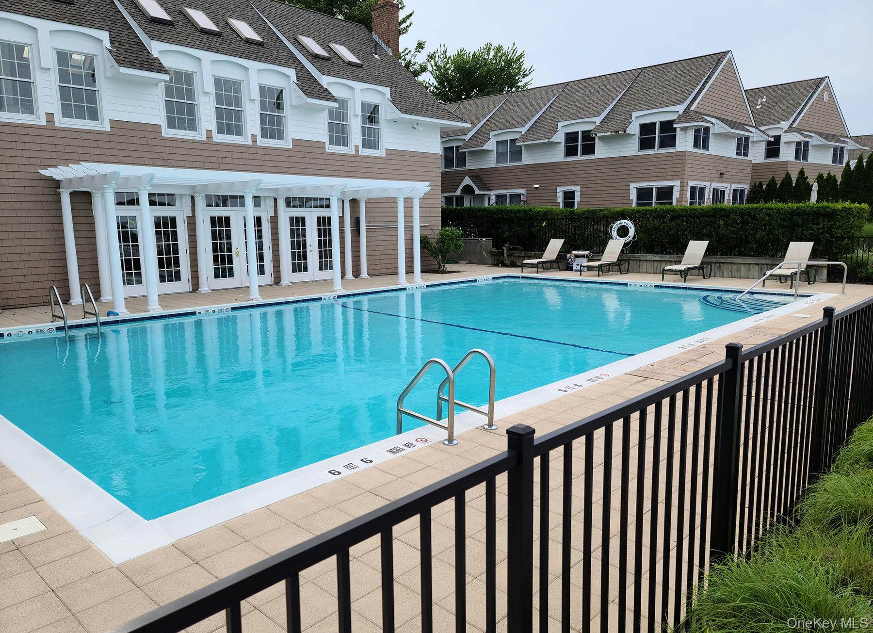 62 Canoe Place Road, Unit 627 Hampton Bays, NY 11946 - Photo 5 of 27 a view of a house with a yard from a balcony