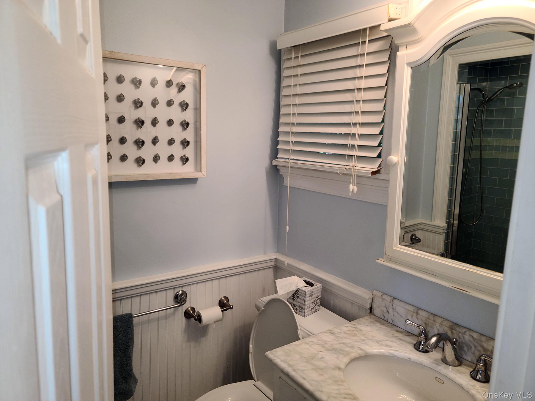 62 Canoe Place Road, Unit 627 Hampton Bays, NY 11946 - Photo 8 of 27 a bathroom with a sink and a mirror