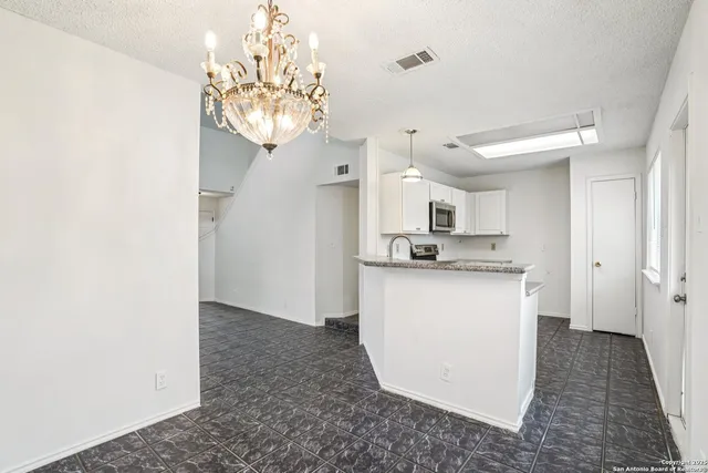 a view of kitchen with refrigerator and window