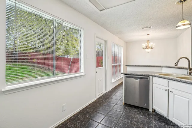 a kitchen with a sink cabinets and window