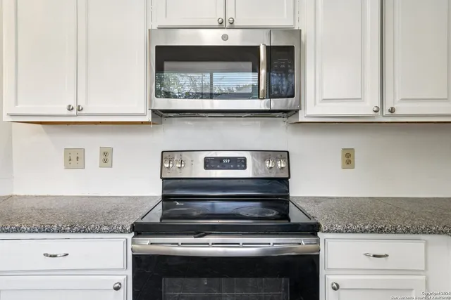 a stove top oven sitting inside of a kitchen