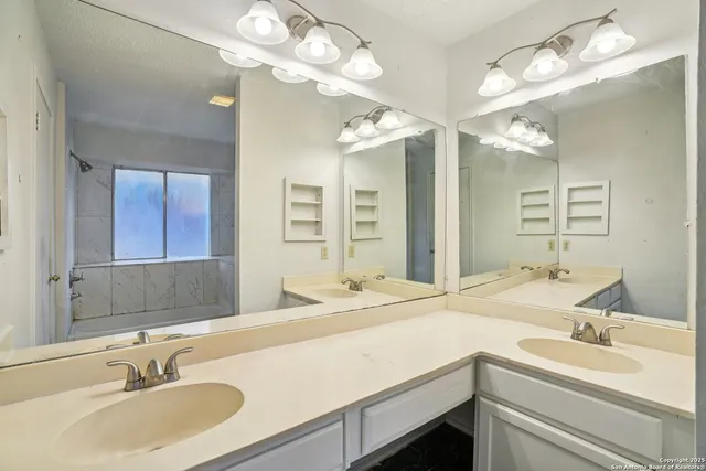 a bathroom with a sink double vanity and a mirror