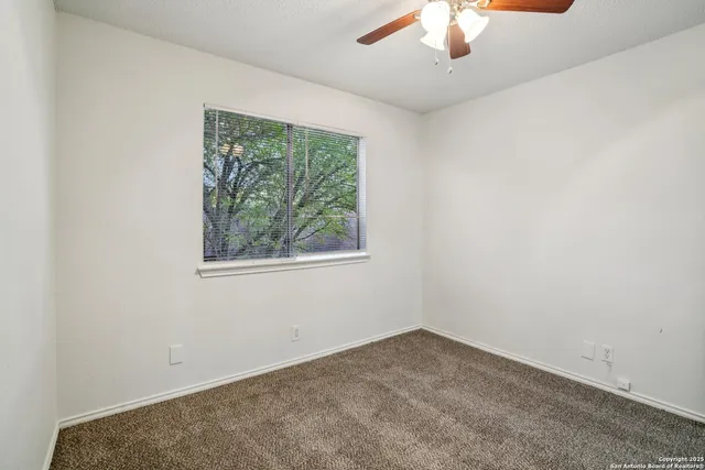 a view of an house with backyard and a tree
