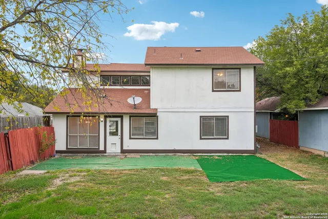 a front view of a house with a garden and yard
