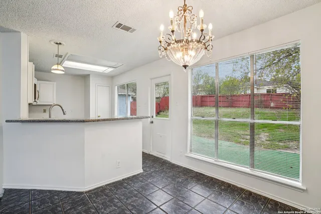 a view of a chandelier and a chandelier in a room
