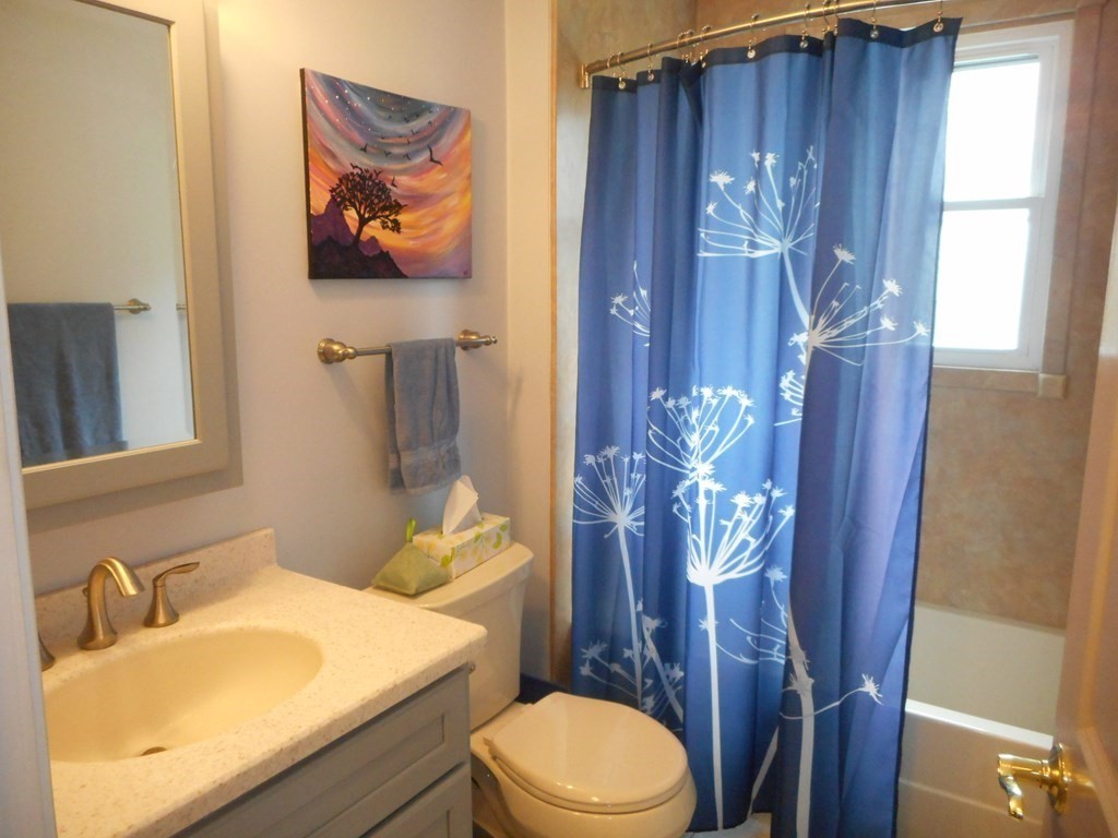 2 Poe Road Billerica, MA 01821 - Photo 11 of 34 a bathroom with a toilet a sink and a mirror