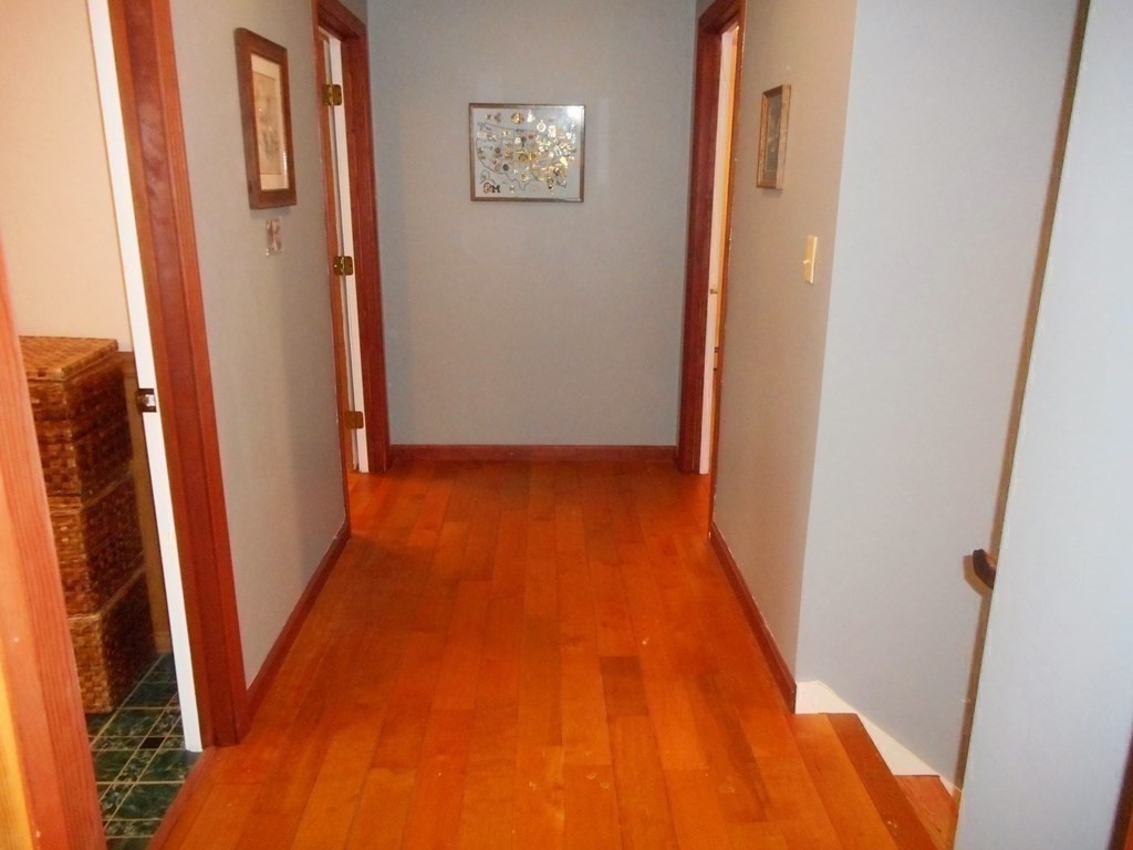 2 Poe Road Billerica, MA 01821 - Photo 17 of 34 a view of a hallway with wooden floor and staircase