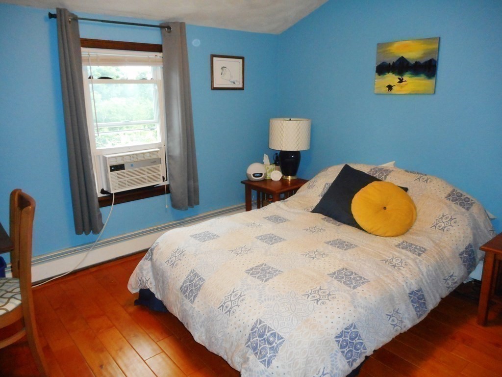 2 Poe Road Billerica, MA 01821 - Photo 18 of 34 a bedroom with bed and wooden floor
