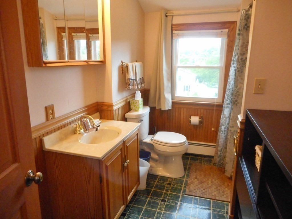 2 Poe Road Billerica, MA 01821 - Photo 21 of 34 a bathroom with a toilet sink and mirror