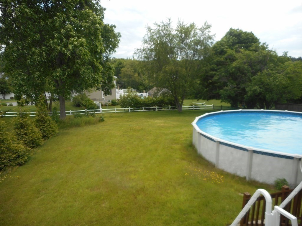 2 Poe Road Billerica, MA 01821 - Photo 32 of 34 a view of a swimming pool with an outdoor space and seating area