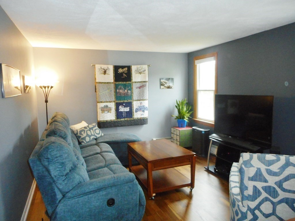 2 Poe Road Billerica, MA 01821 - Photo 4 of 34 a living room with furniture and a flat screen tv