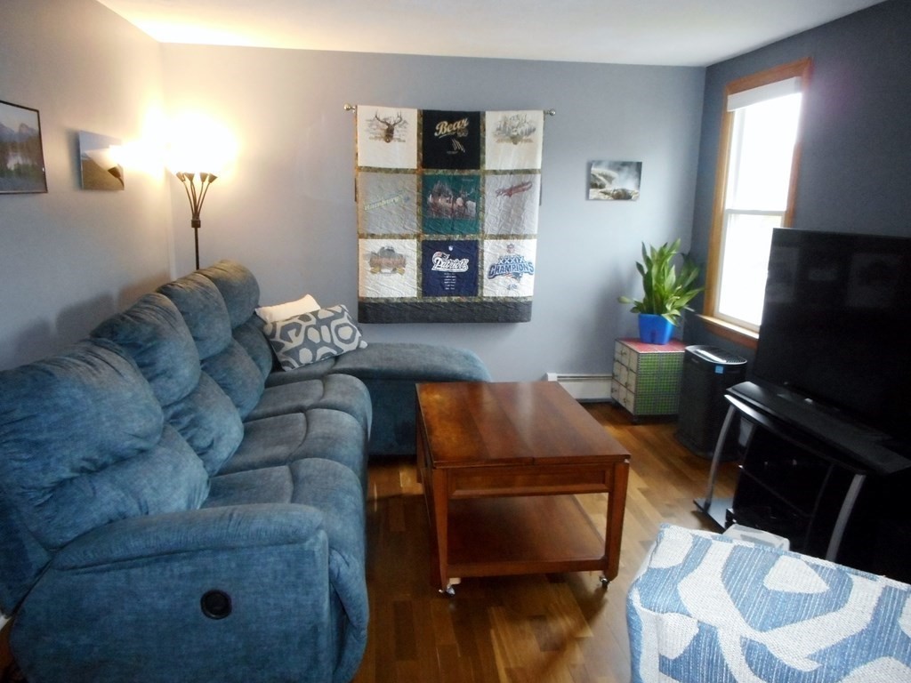 2 Poe Road Billerica, MA 01821 - Photo 5 of 34 a living room with furniture and a flat screen tv