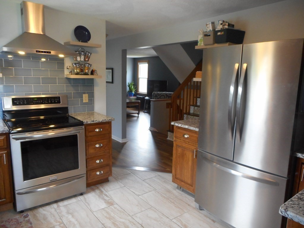 2 Poe Road Billerica, MA 01821 - Photo 10 of 34 a kitchen with stainless steel appliances granite countertop a refrigerator and a stove top oven