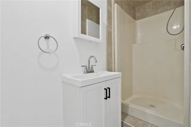 a bathroom with a sink mirror and vanity
