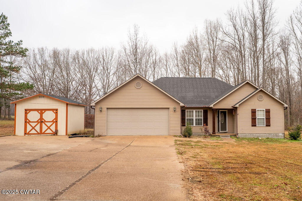 a view of a house with a yard and trees